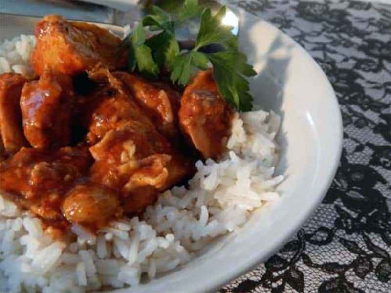 Authentic Portuguese Chicken Mozambique served over white rice with rich lemon garlic sauce