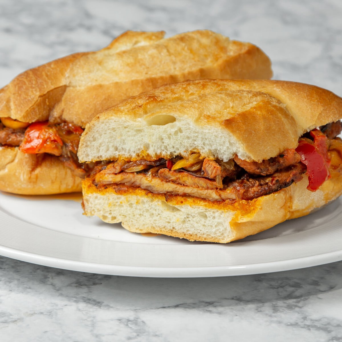 Sweet sautéed onions complete the classic Bifana sandwich.