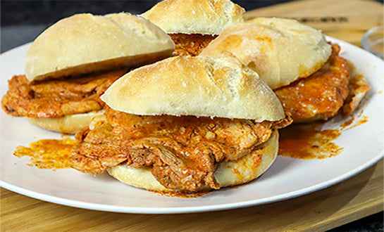 Traditional Portuguese Bifana pork sandwich made with marinated pork on a Portuguese roll