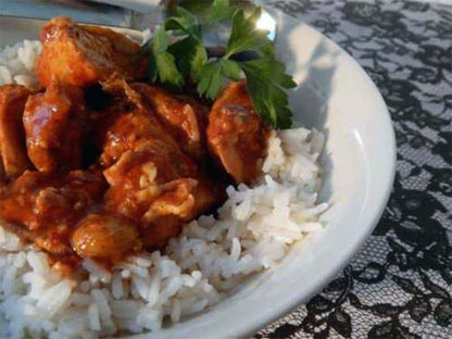 Authentic Portuguese Chicken Mozambique served over white rice with rich lemon garlic sauce